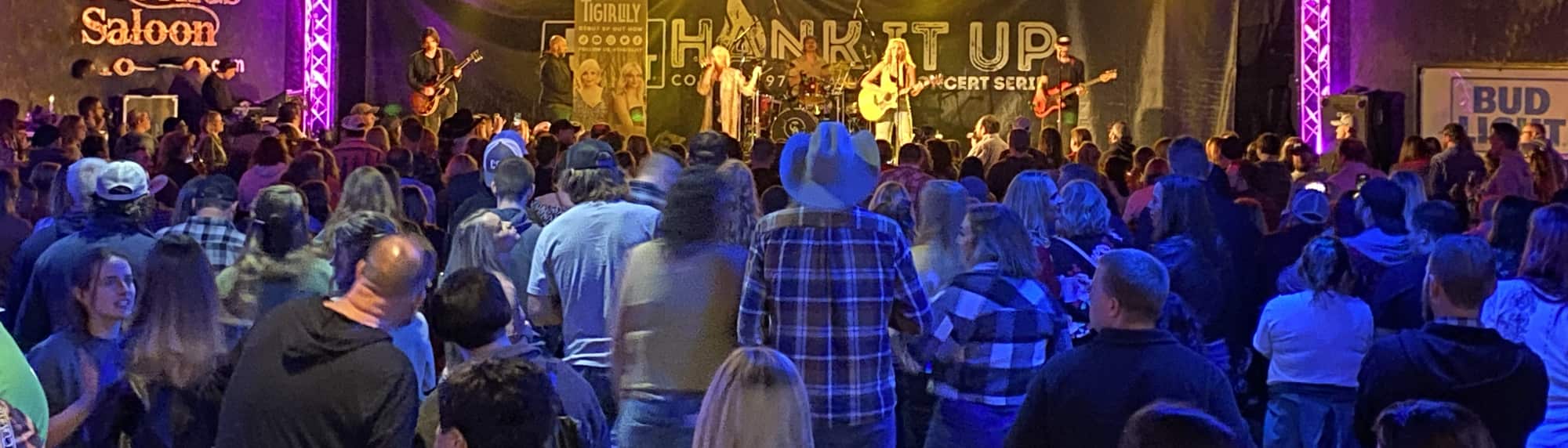 country concert with fans wearing cowboy hats Boston